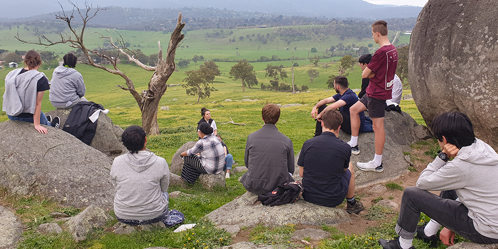 The group listens as they appreciate the beauty of their surrounds