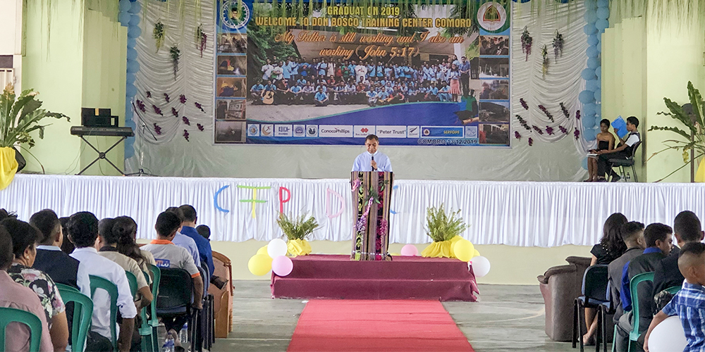 Fr Neto gives a speech to students