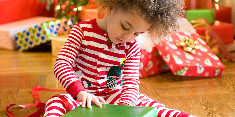 Young person opens Christmas present